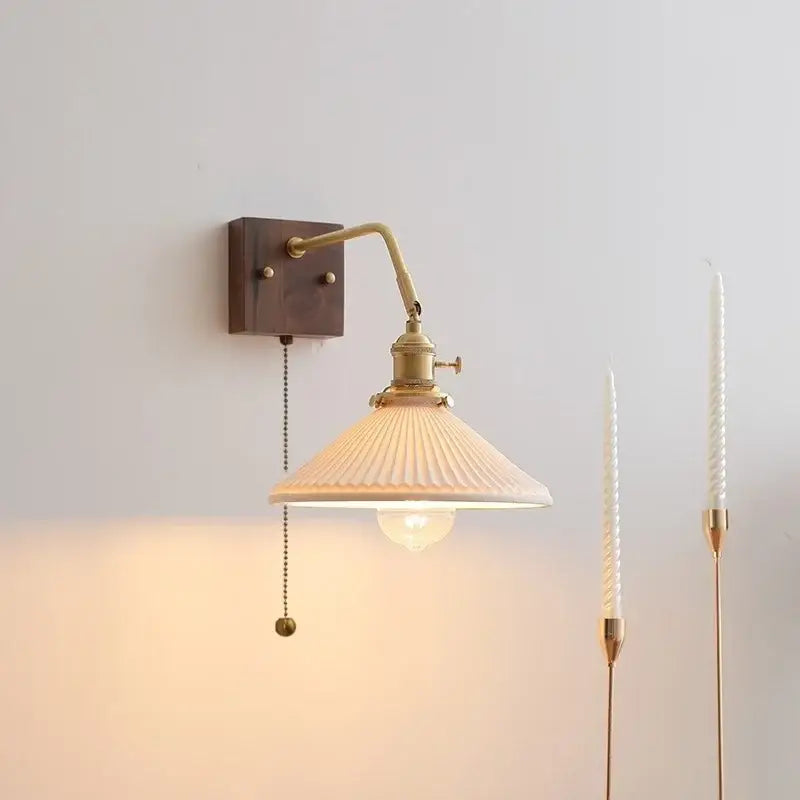 Vintage brass ceramic led wall sconce with ribbed off-white scalloped glass shade and dark wood mounting plate decorbites ceramic led wall