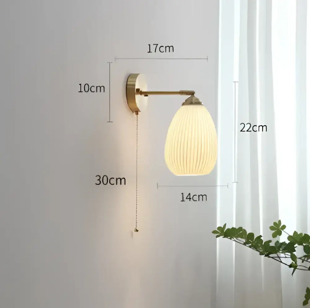 Vintage brass ceramic wall lamp with warm-toned ribbed glass shade and brass knob switch for decorbites ceramic wall use