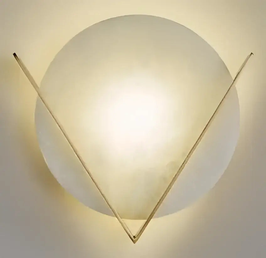 A modern vintage brass decorbites ceramic wall lamp with frosted glass globe and gold-toned triangular frame for bedroom