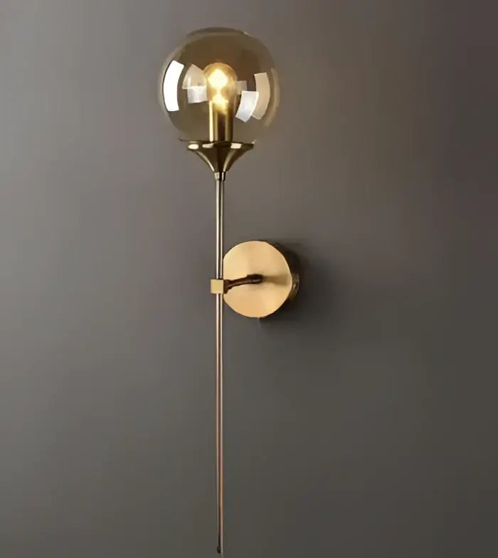 Vintage brass ceramic wall lamp with gold-toned spherical glass globe and slender metallic stem for bedroom decorbites ceramic wall lamp