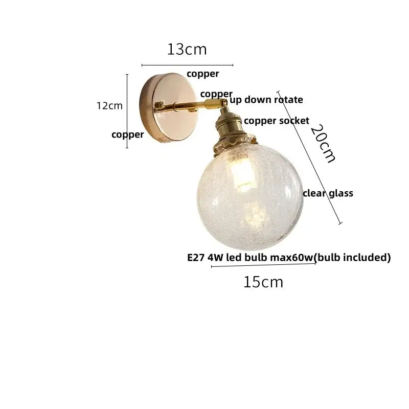 Vintage brass wall lamp with copper mounting bracket and clear glass globe featuring pull chain switch for bathroom use