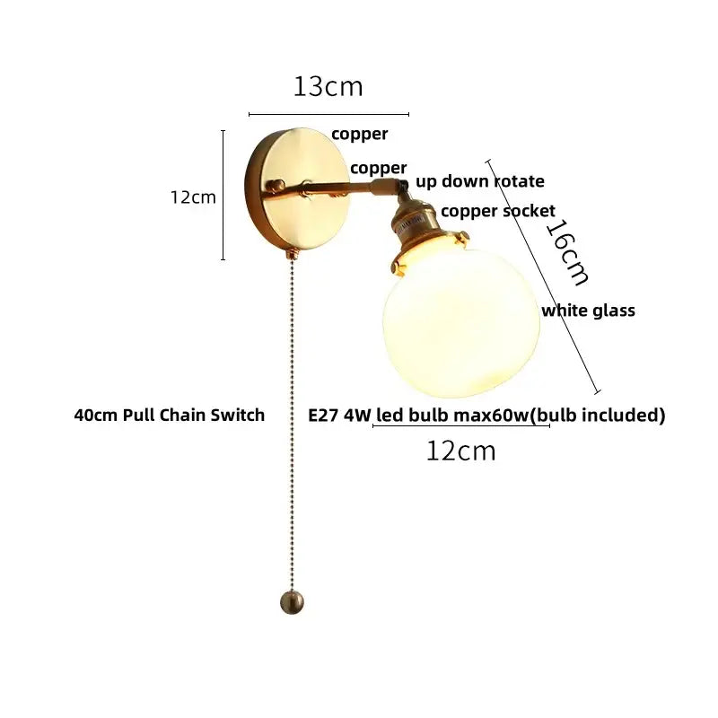 Copper-finished vintage brass wall lamp with clear glass globe and adjustable arm featuring pull chain switch for bathroom