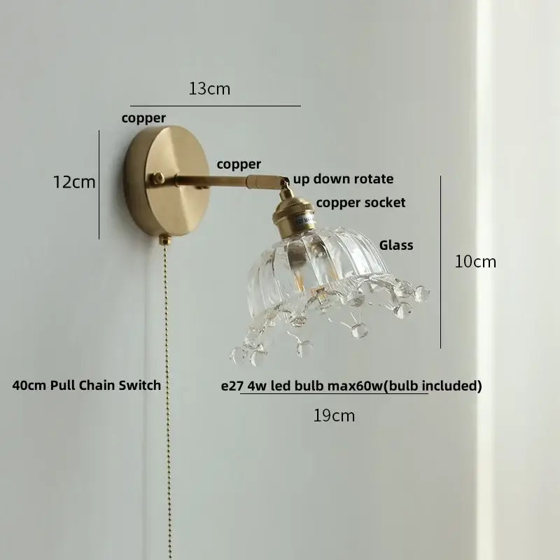 Vintage brass wall lamp with clear glass shade, pull chain switch, and crystal droplets for bathroom use