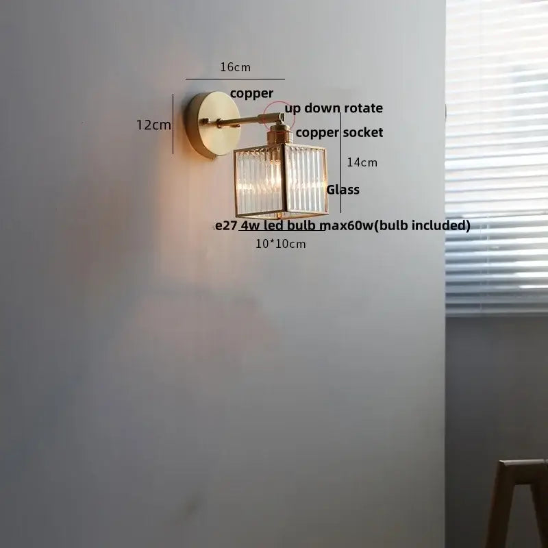 Copper wall lamp with rectangular clear glass shade featuring vertical ridges and pull chain switch for bathroom use