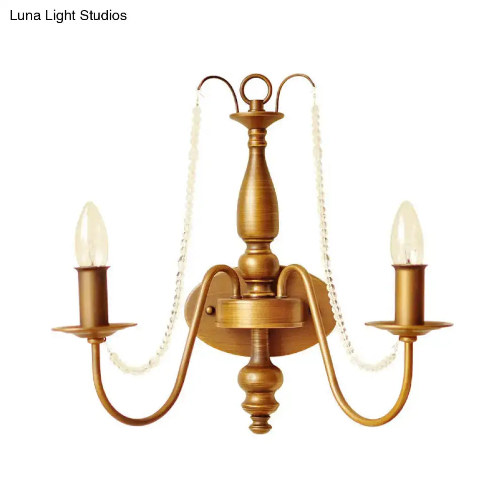 Antique brass two-light wall sconce with crystal chain accents vintage brass crystal bead bedroom candle light