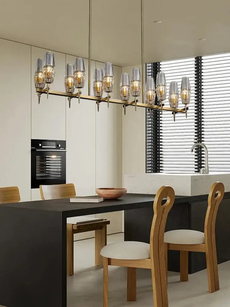 Modern brass crystal chandelier lights with clear glass shades and warm glowing bulbs for dining room decorbites brass crystal