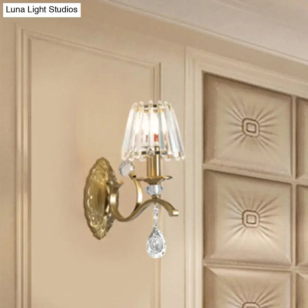 Vintage brass crystal fringe wall sconce with gold-toned finish, teardrop crystals, and e14 bulb base light type fixture height