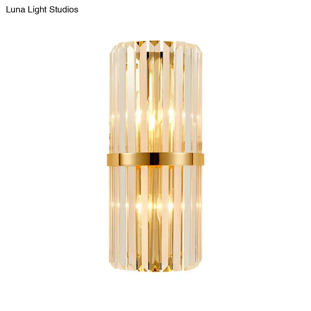 Elegant vintage brass crystal wall lamp with gold finish, vertical crystal rods, and central metallic band for living room