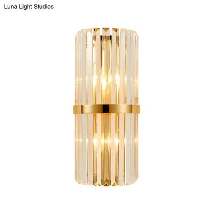 Elegant vintage brass crystal wall lamp with gold finish, vertical crystal rods, and central metallic band for living room