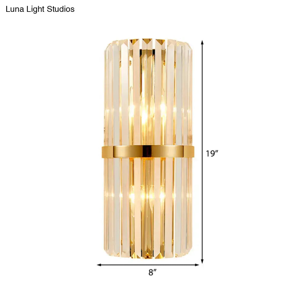 Vintage brass crystal wall lamp featuring vertical crystal rods and a polished gold band for living room use