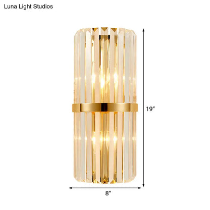 Vintage brass crystal wall lamp featuring vertical crystal rods and a polished gold band for living room use