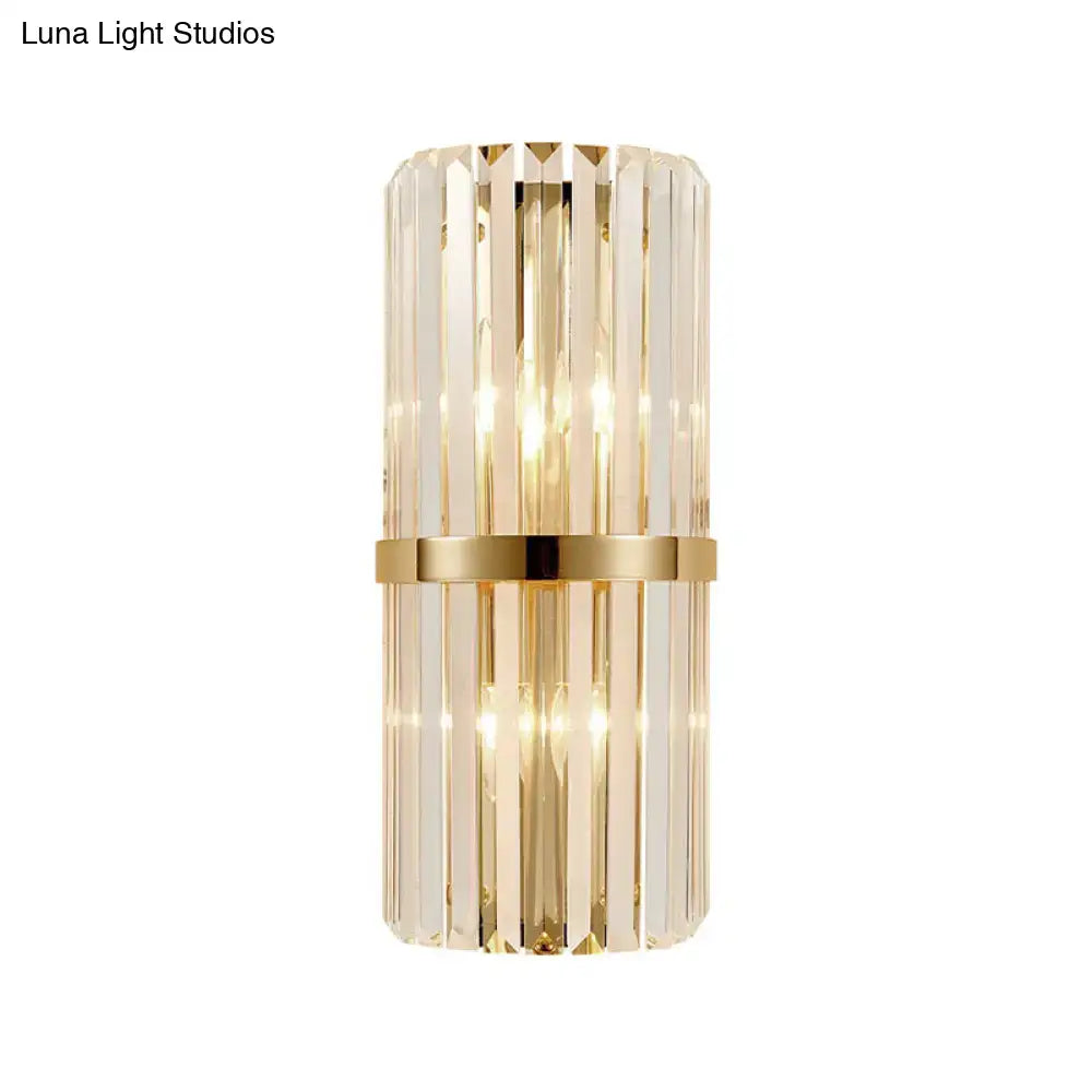 Vintage brass crystal wall lamp featuring a sleek cylindrical design with vertical crystal prisms for living room use