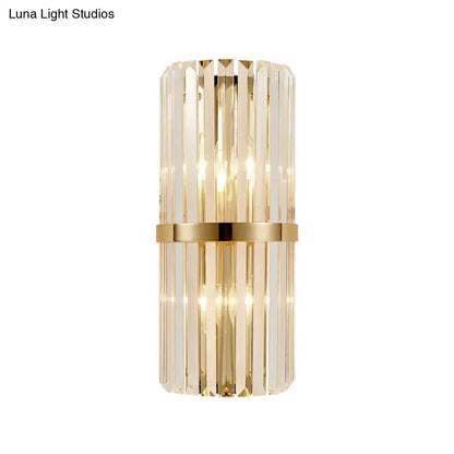 Vintage brass crystal wall lamp featuring a sleek cylindrical design with vertical crystal prisms for living room use