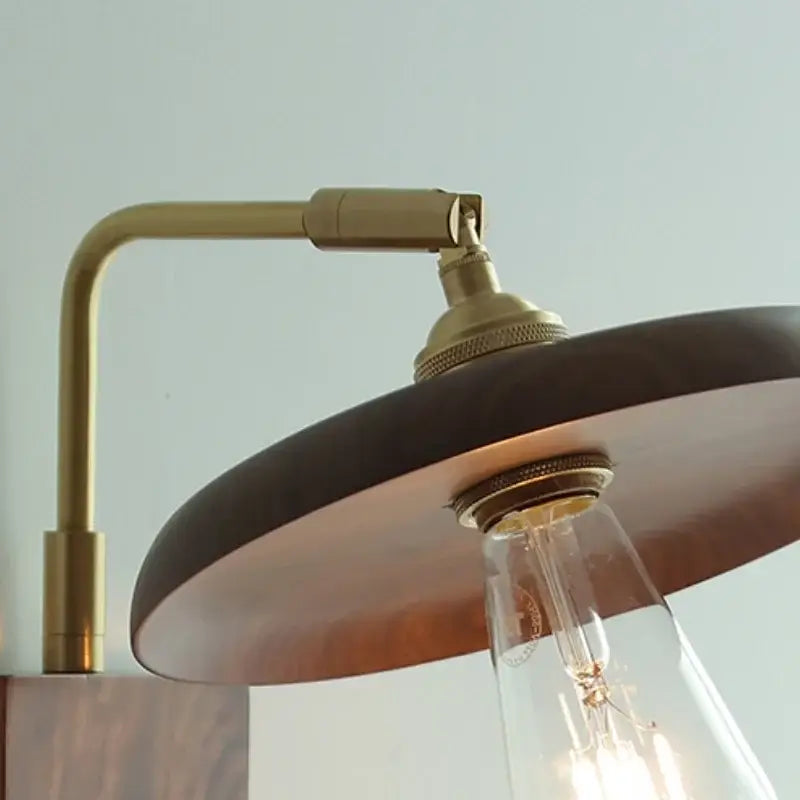 Vintage brass and dark wood wall light sconce with adjustable arm and exposed filament bulb for bedroom decorbites copper style