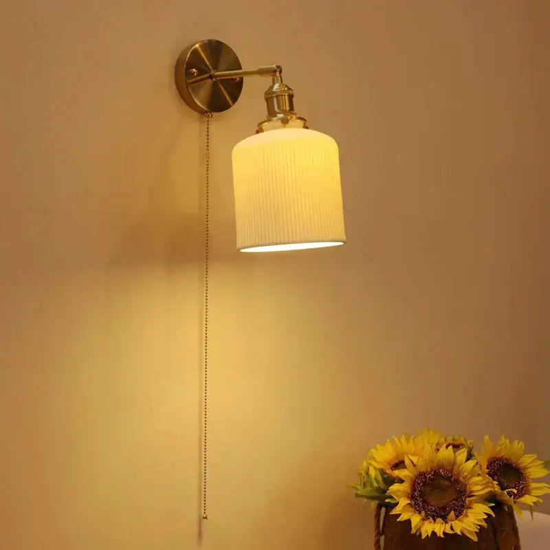 Vintage brass decorbites ceramic sconce lamp with ribbed off-white glass shade and pull chain for bedroom reading light
