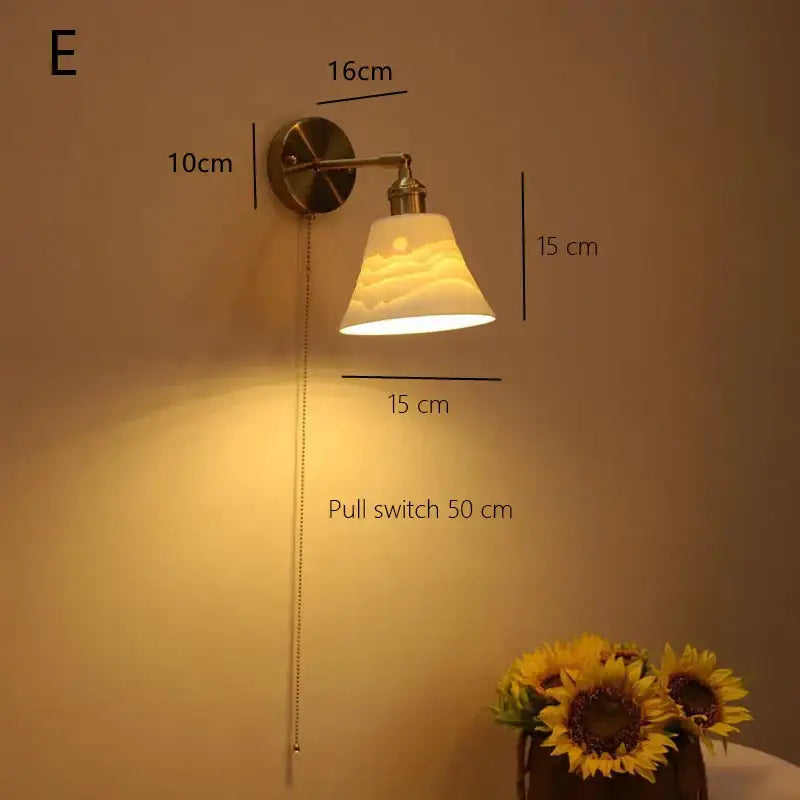 Warm-toned vintage brass decorbites ceramic sconce lamp with frosted cloud-embossed glass shade for bedroom reading light