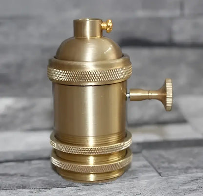 Vintage brass e27 lamp holder featuring a textured socket with ridged bands and a knurled adjustment knob for living room use