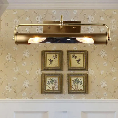 Vintage brass finish wall-mounted vanity lamp with two illuminated bulbs and sleek cylindrical design for bathroom