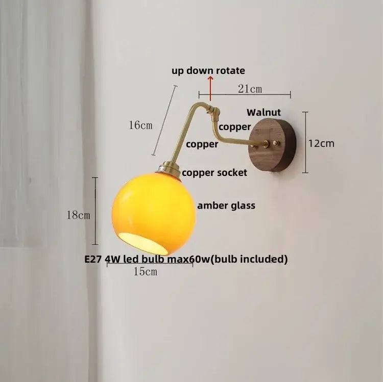 Copper-finished vintage brass led wall lights with spherical amber glass shade and walnut wood backplate with rotate pull chain