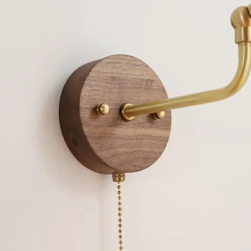 A sleek vintage brass led wall light with walnut base and rotate pull chain for decorbites led wall bedroom use