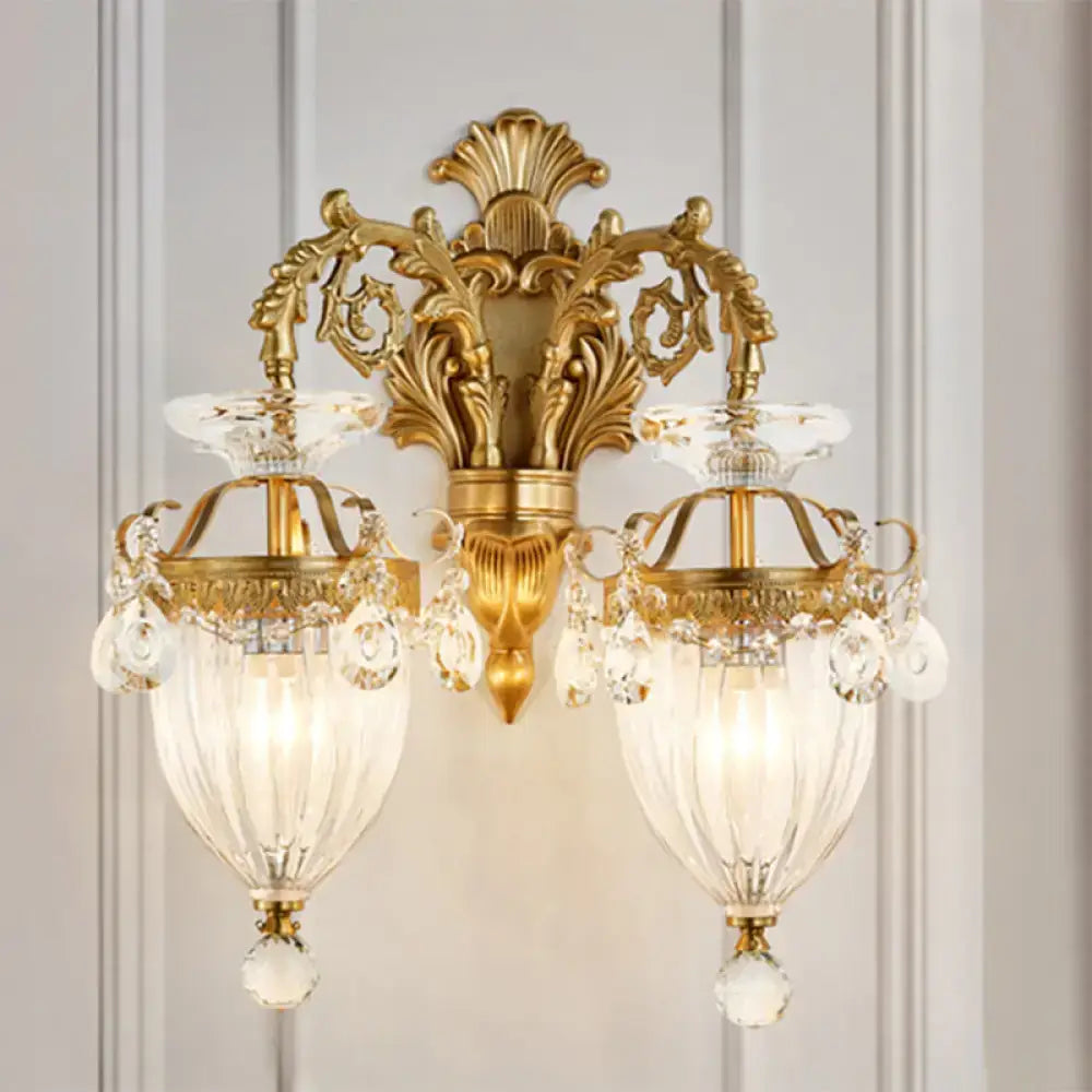 Vintage brass wall lamp with gold-toned ornate design, fluted glass shades, and dangling crystals, approximately 15 inches high