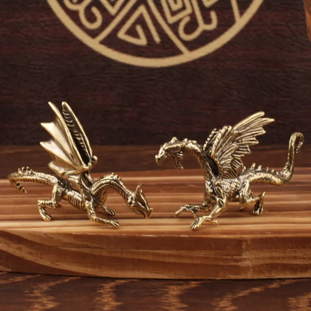 Two intricately detailed brass flying dragon sculptures with textured scales and spread wings for living room decorbites decor