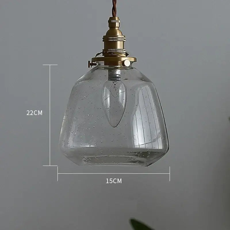 Clear glass led pendant light with vintage brass finish and exposed filament bulb for dining room use