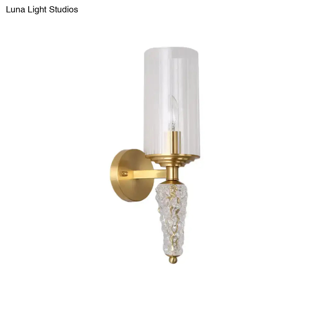Vintage brass wall mounted lighting fixture with gold-toned finish clear glass shade and textured crystal base
