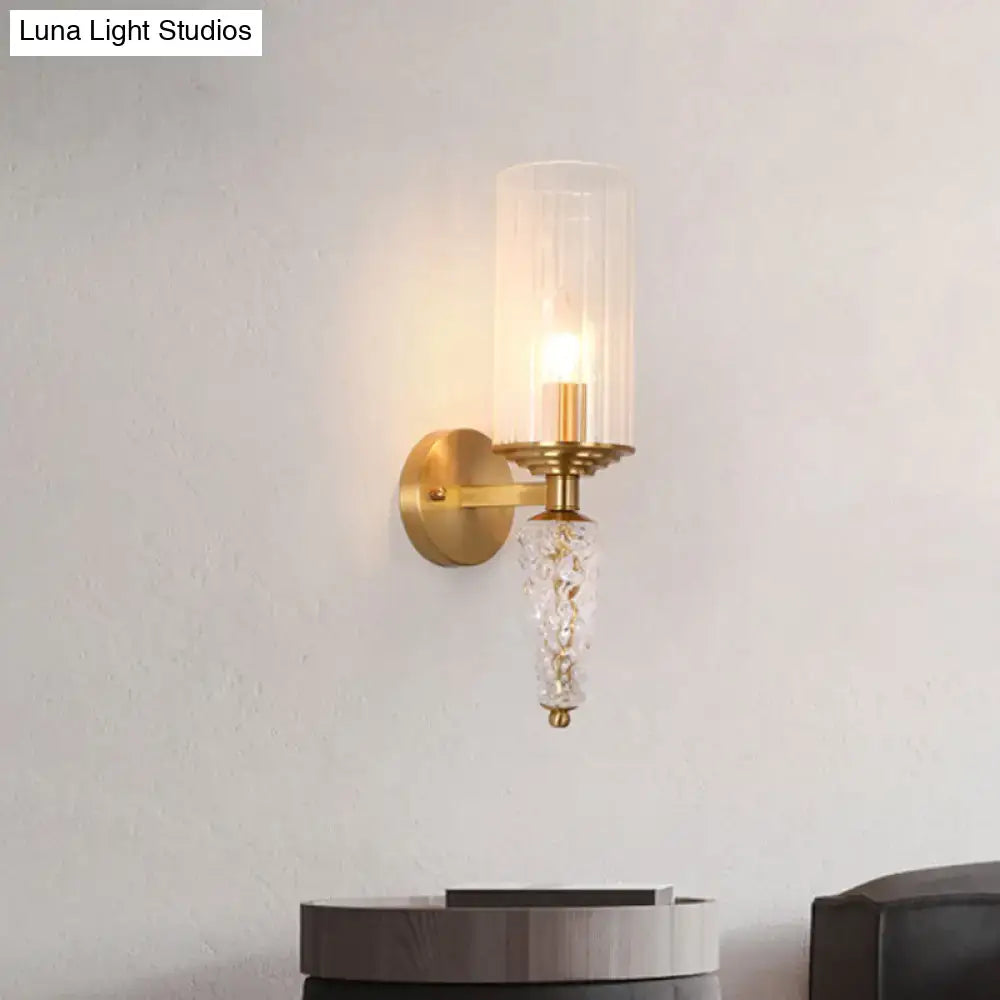 Vintage brass wall mounted lighting fixture with gold-toned glass shade and ornate faceted crystal pendant for bedroom use