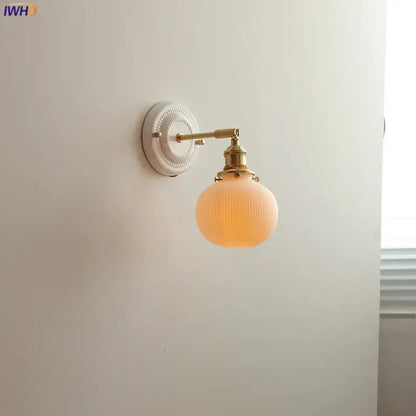 Vintage brass globe wall sconce with opalescent ribbed glass and brass-finished decorbites copper arm led fixture