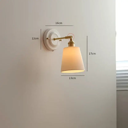 Vintage brass globe wall sconce with decorbites copper arm led and beige fabric shade diffusing warm light