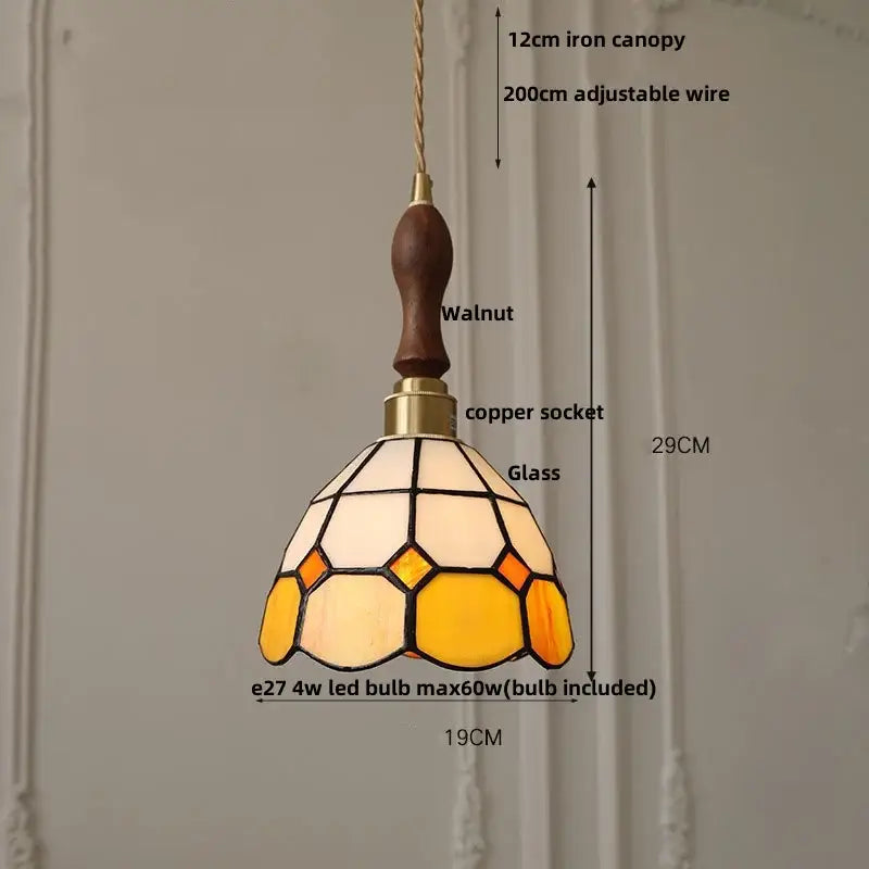 Vintage brass led pendant light with amber glass and walnut iron canopy featuring geometric cream and amber patterns