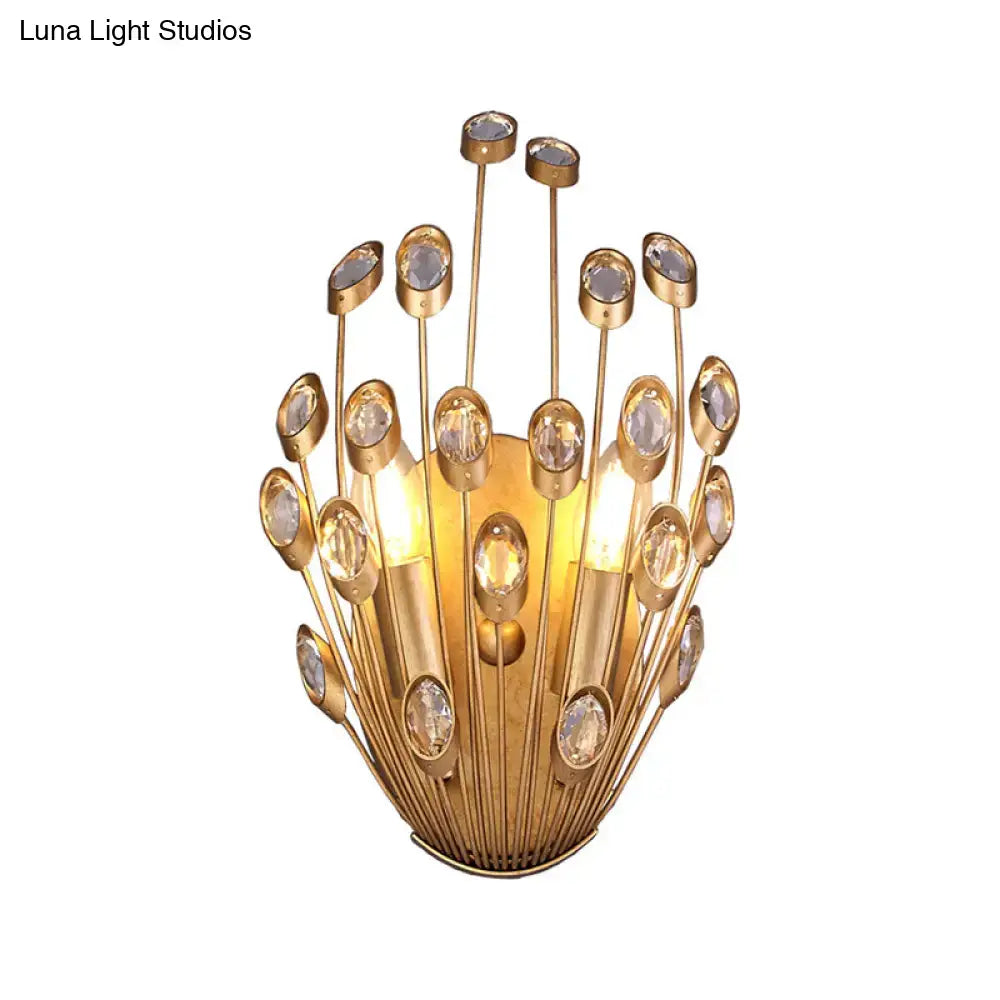Vintage brass wall sconce with peacock tail design featuring gold-toned metal and clear crystal orbs for bedroom use