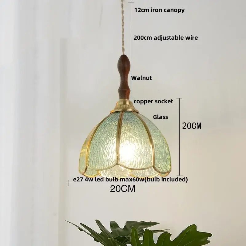 Vintage brass petal glass led pendant light featuring a textured green glass shade with brass accents and walnut canopy