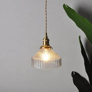 A warm-toned vintage brass ribbed glass led ceiling chandelier with clear glass shade for bedroom lighting