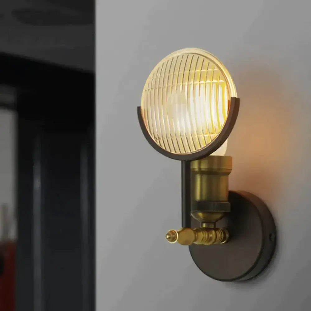 Vintage brass ribbed glass led wall lamp sconce with circular lens emitting warm light for bedroom lighting