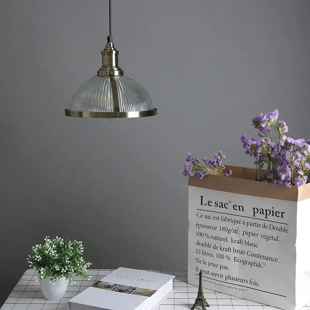 Vintage brass pendant light with ribbed glass shade designed as elegant glass pendant lights for living room use