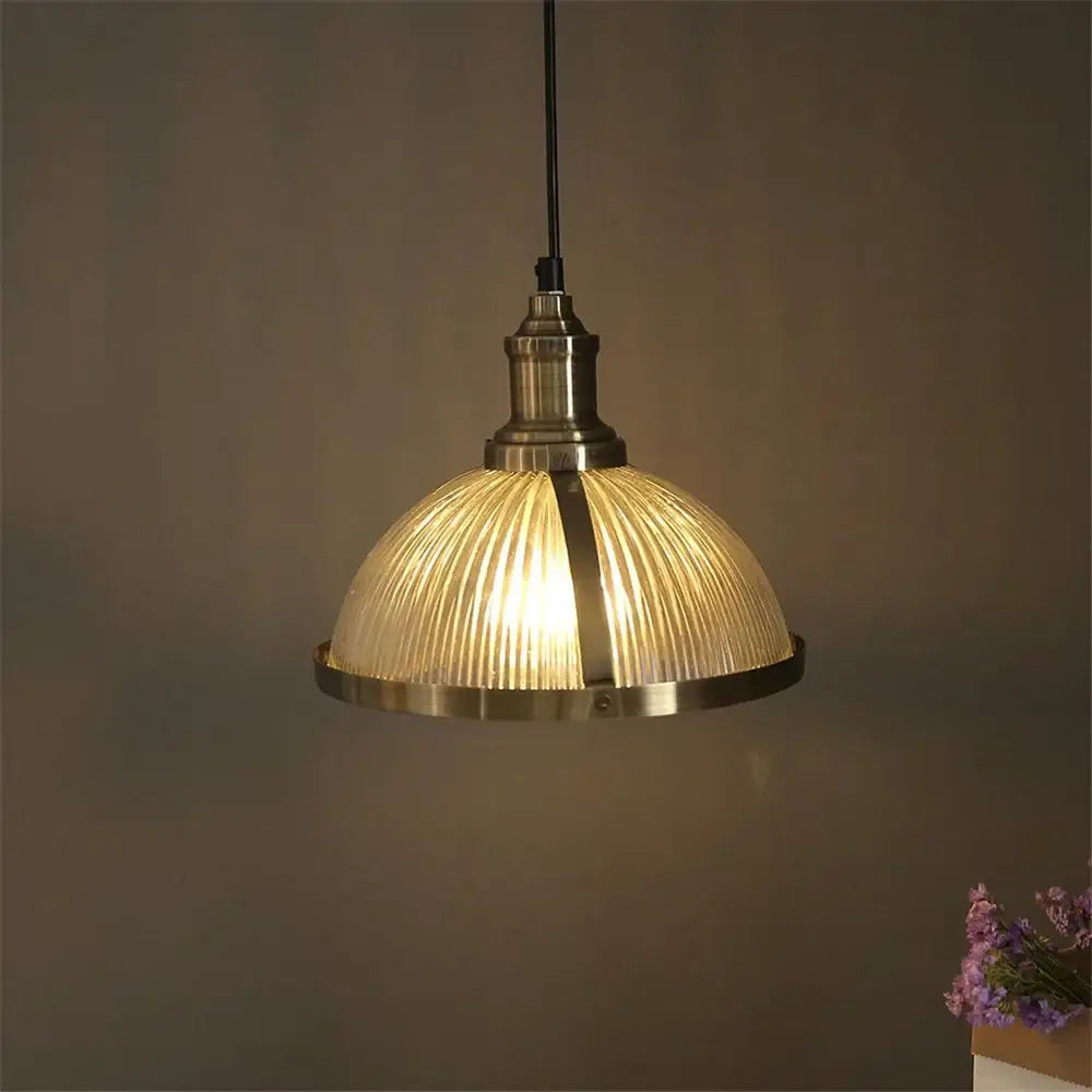 Vintage brass ribbed glass pendant light featuring warm-toned glass shade ideal for living room pendant lights