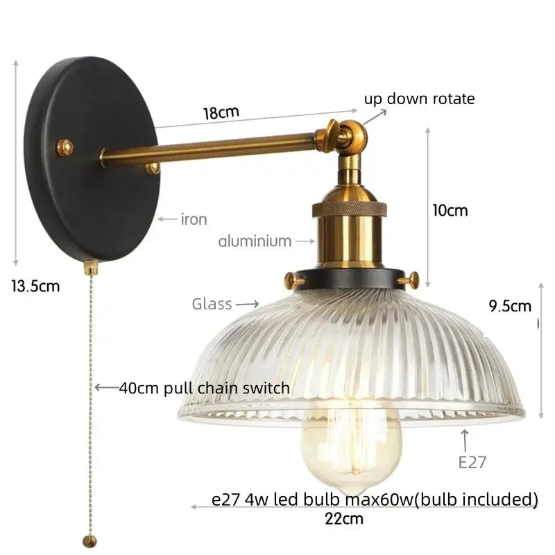 Vintage brass ribbed glass wall sconce with black iron backplate and pull chain switch for bedroom lighting
