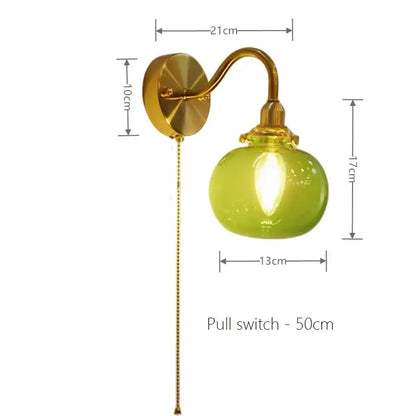 Vintage brass wall sconce lamp with lime green ribbed glass globe and pull chain switch for bedroom lighting