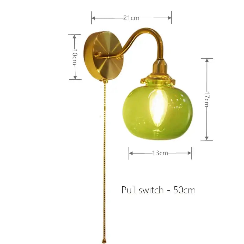 Vintage brass wall sconce lamp with lime green ribbed glass globe and pull chain switch for bedroom lighting