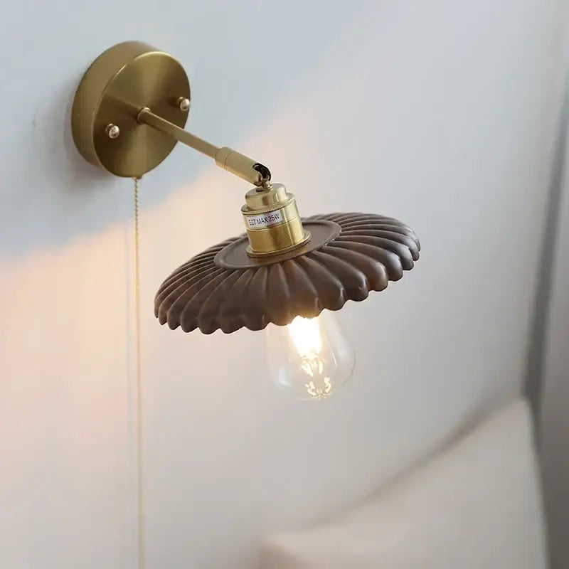 Vintage brass scalloped wall lamp with fluted dark brown shade and exposed edison bulb light fixture for bedroom