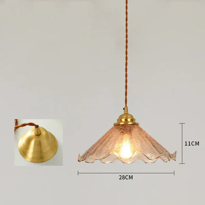 A warm-toned vintage brass scalloped glass led pendant lamp with a twisted cord for bedroom lighting