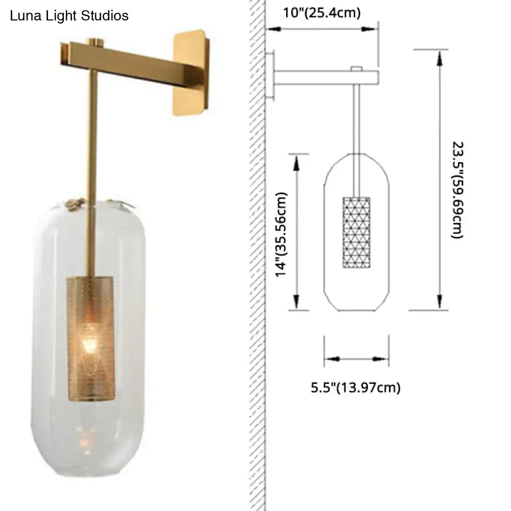 Vintage brass wall lamp with clear glass cylinder shade and illuminated brass mesh interior for living room use