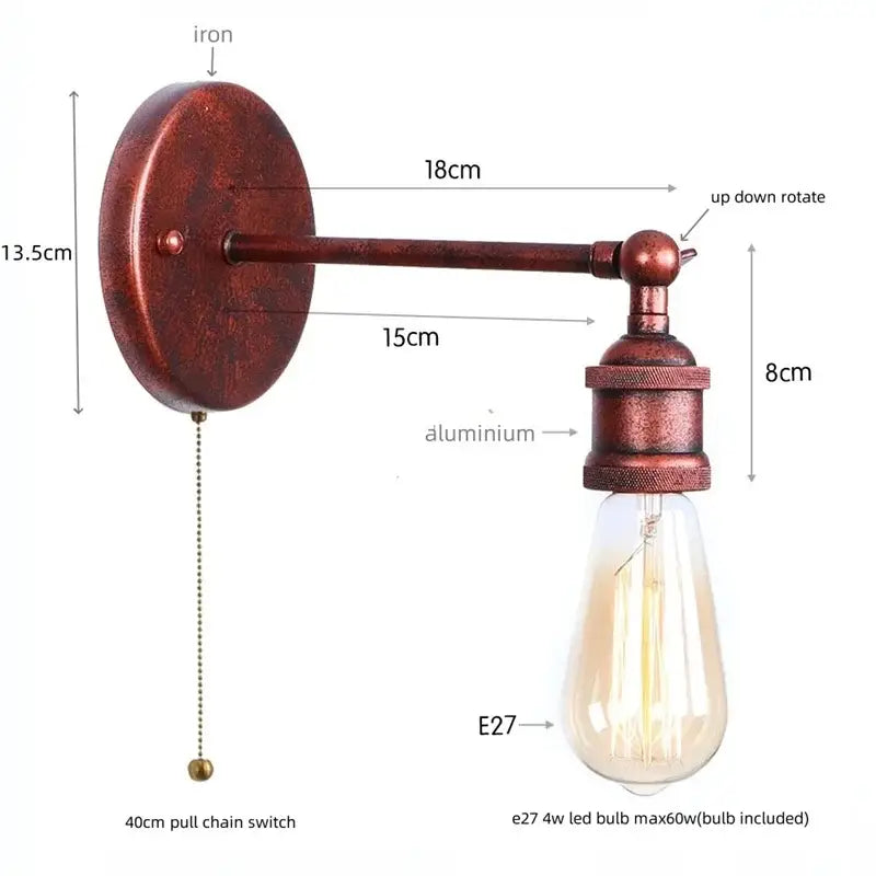 Vintage brass wall lamp with pull chain featuring gold vintage iron, rusted iron backplate, aluminum arm, and clear glass shade