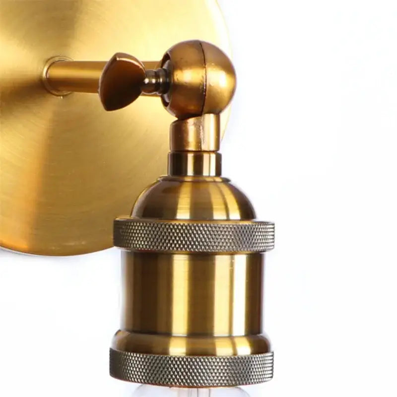 Antique brass wall lamp with textured knurled base and adjustable arm in decorbites gold vintage iron for bedroom use