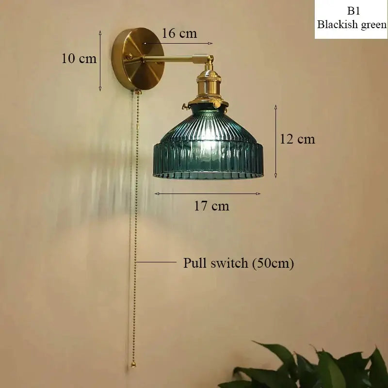 Vintage brass wall lamp with a blackish green ribbed glass shade and brass-finished metal hardware for living room use