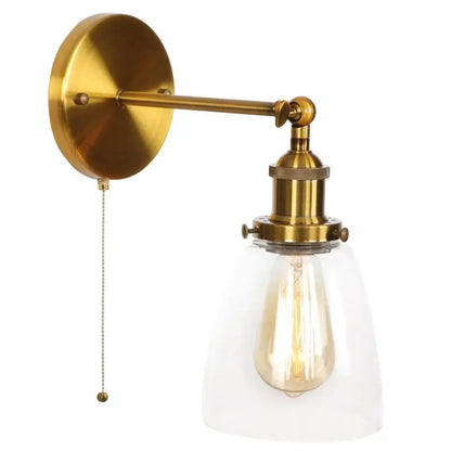 Vintage brass wall light fixture with clear glass dome and exposed filament bulb for bedroom use
