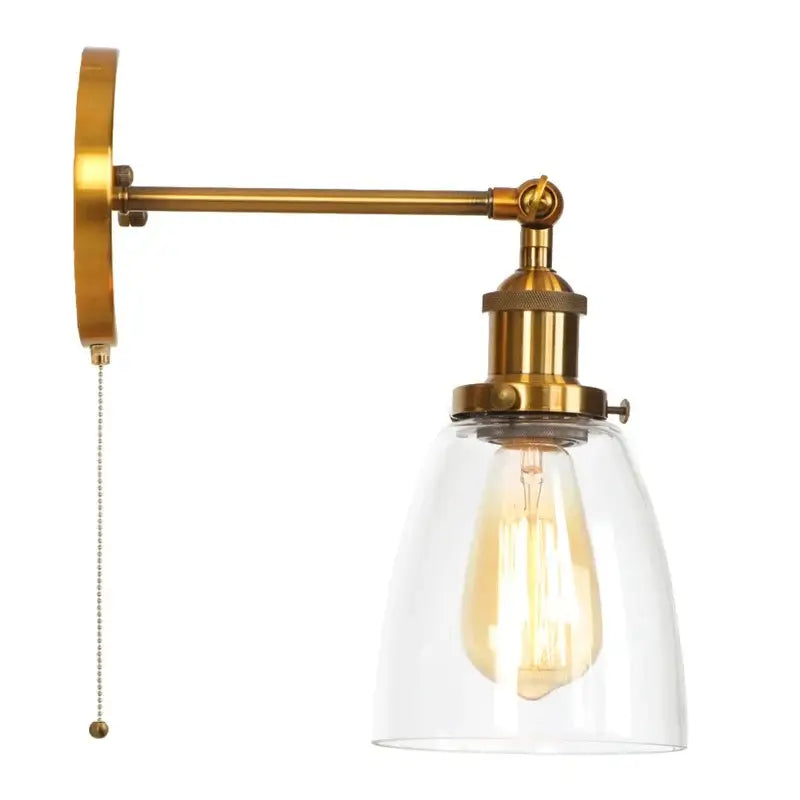 Vintage brass wall light fixture with clear glass dome and exposed filament bulb featuring pull-chain switch for bedroom