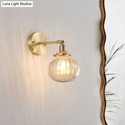 Vintage brass wall light with champagne clear ribbed glass shade and amber tinted globe for bedroom lighting